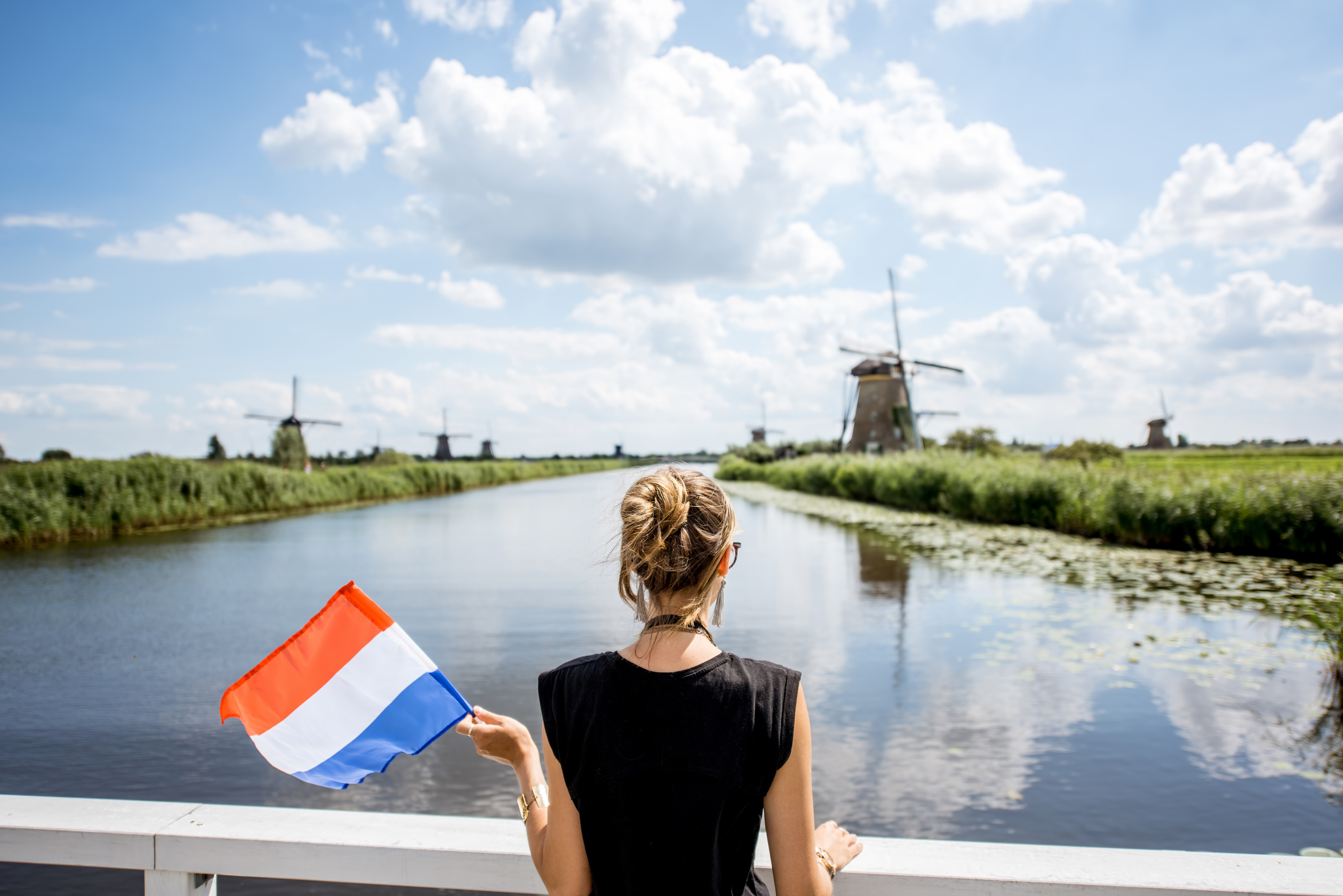Vrouw kijkt naar de molens van Kinderdijk in Nederland