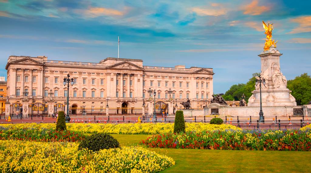 Der Buckingham Palace mit lebhaften Blumengärten und dem Victoria Memorial unter einem farbenfrohen Himmel