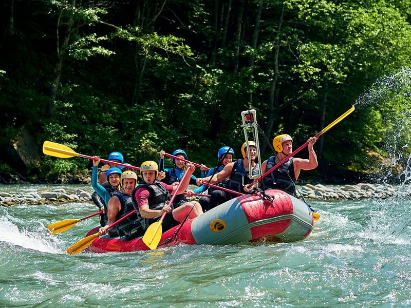 A group of people whitewater rafting