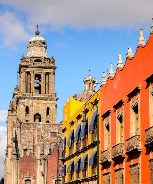 A row of colorful buildings leading to a stone church