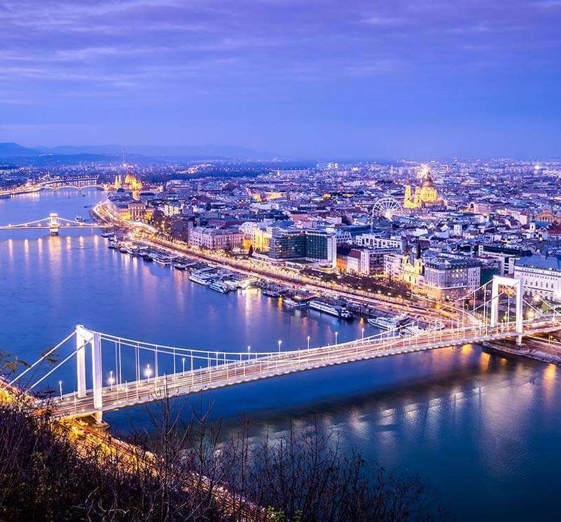 Aerial view of a city along a river at night