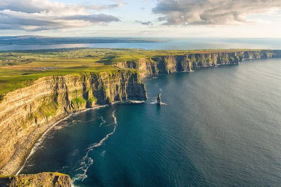 A view of the Cliffs of Moher in Ireland next to the ocean