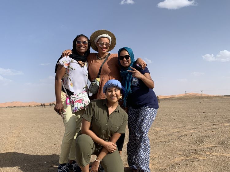 people posing in desert landscape