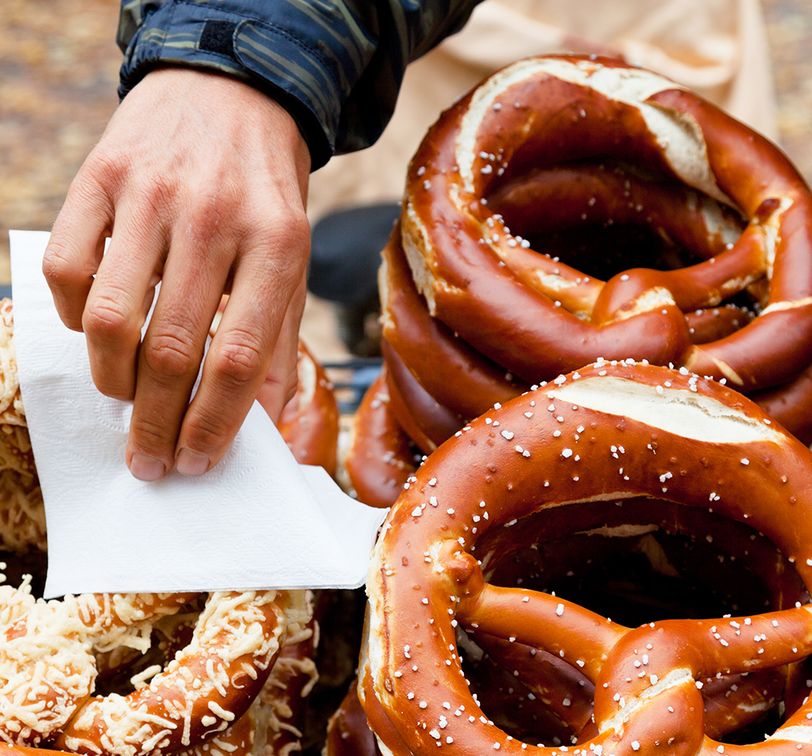 hand grabbing german pretzel