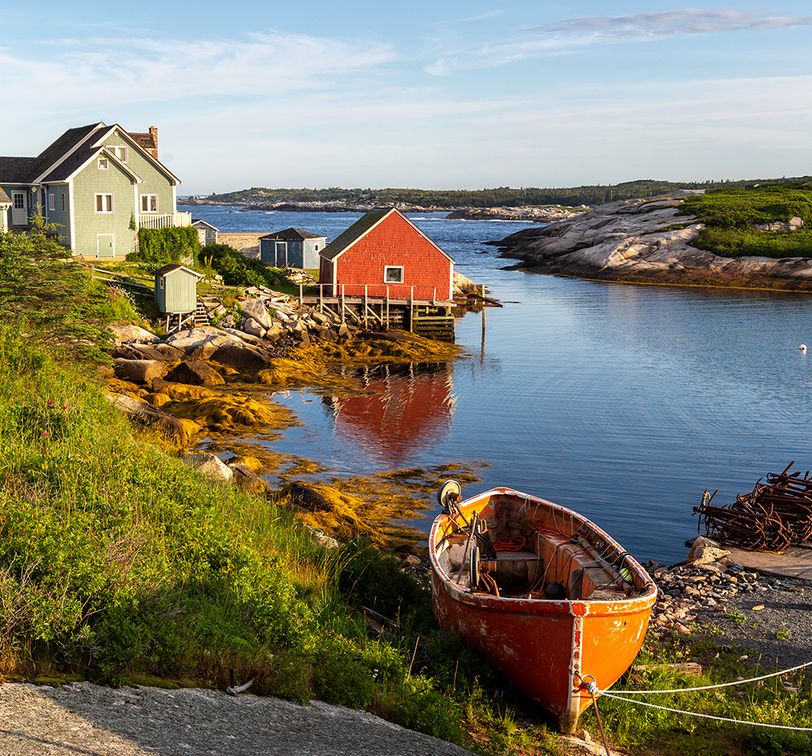 red house and boat on coast