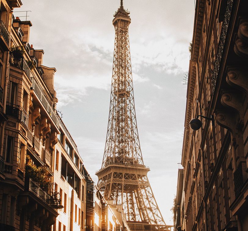 looking up at the eiffel tower at sunset