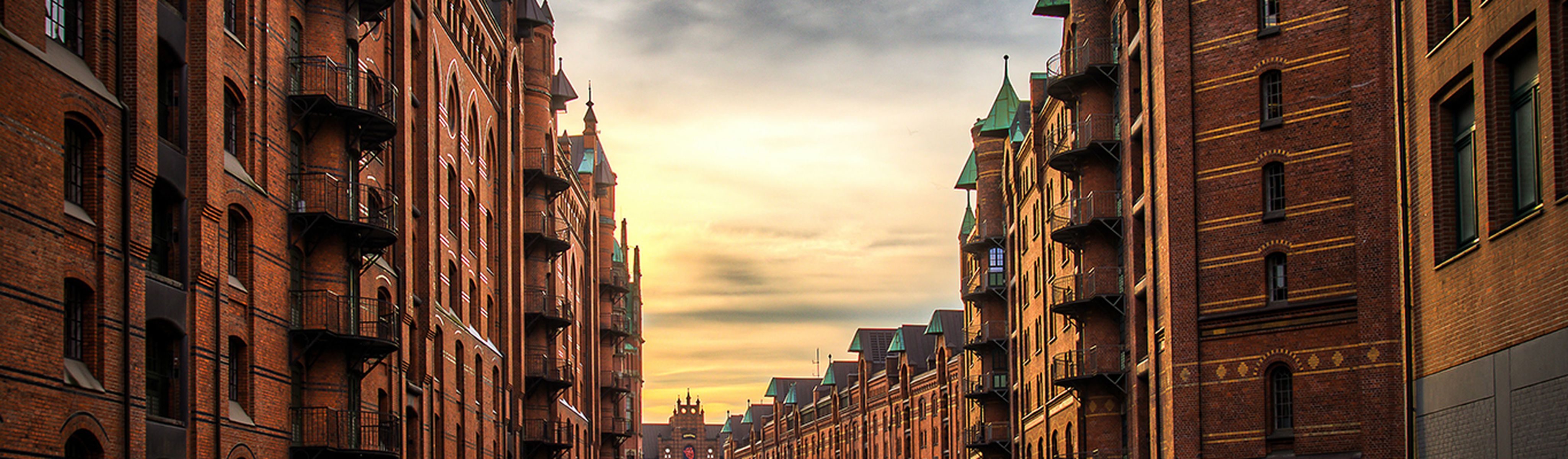 buildings surrounding the river in hamburg germany at sunset