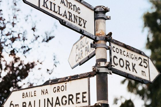 metal street sign with directions to cork and killarney