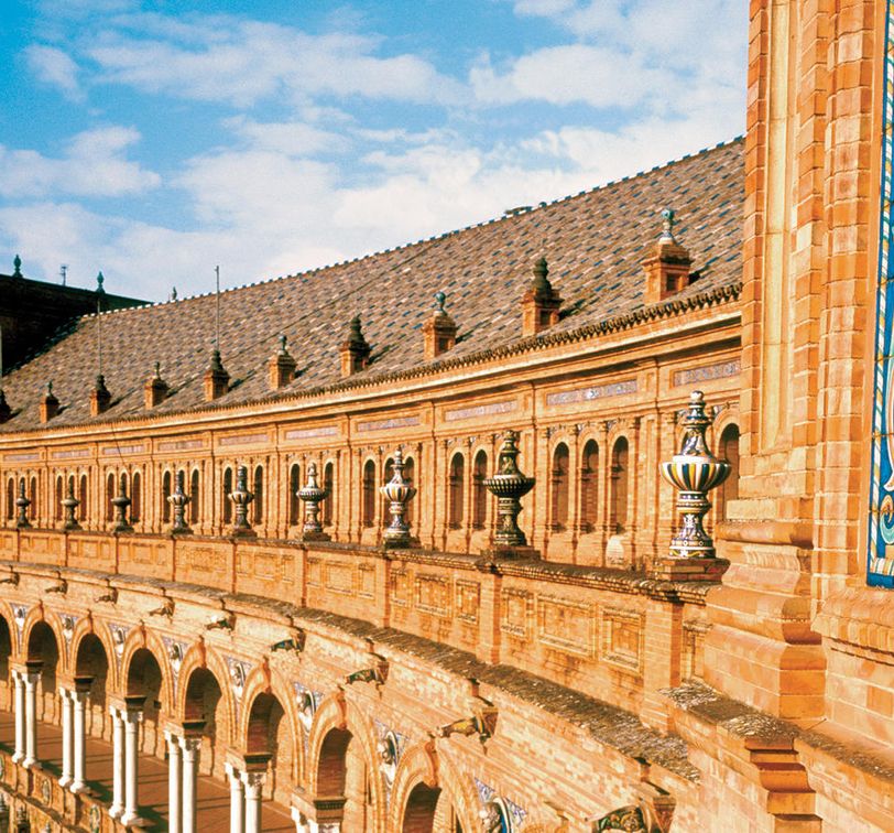 sun shining on the plaza de espana in seville spain