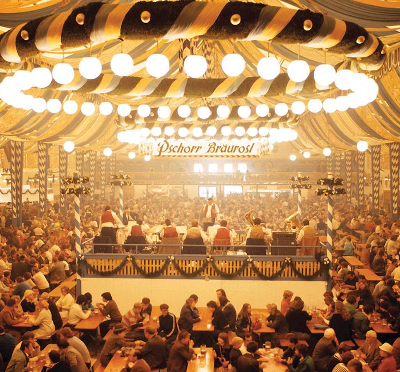people drinking in german beer tent at oktoberfest in munich