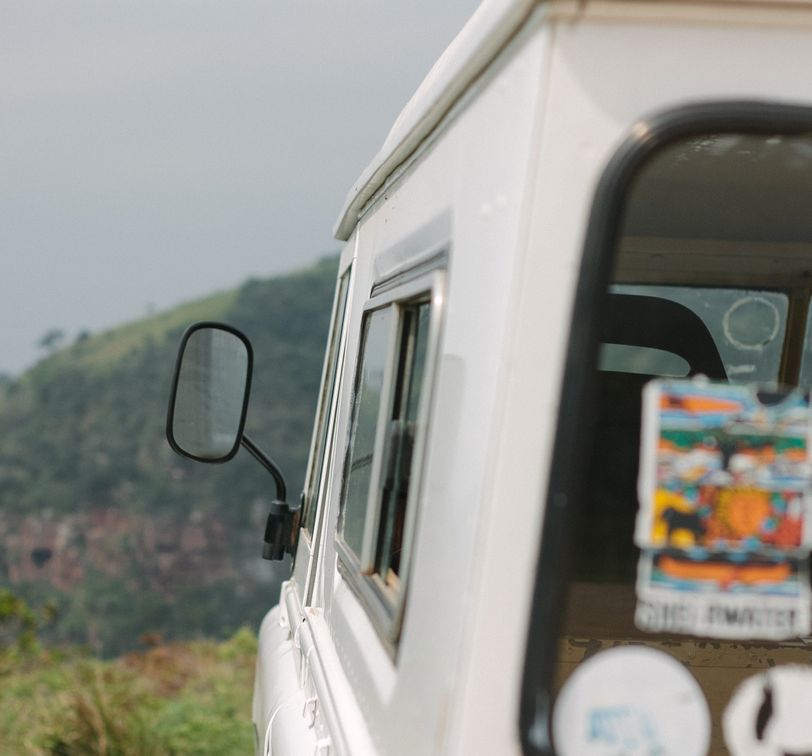 a white van parked on the edge of a hill