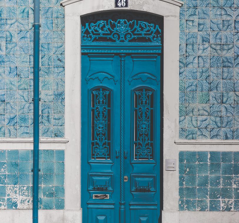 an ornate blue door on the street in portugal