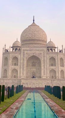 the taj mahal and the reflecting pool in front of it at sunset