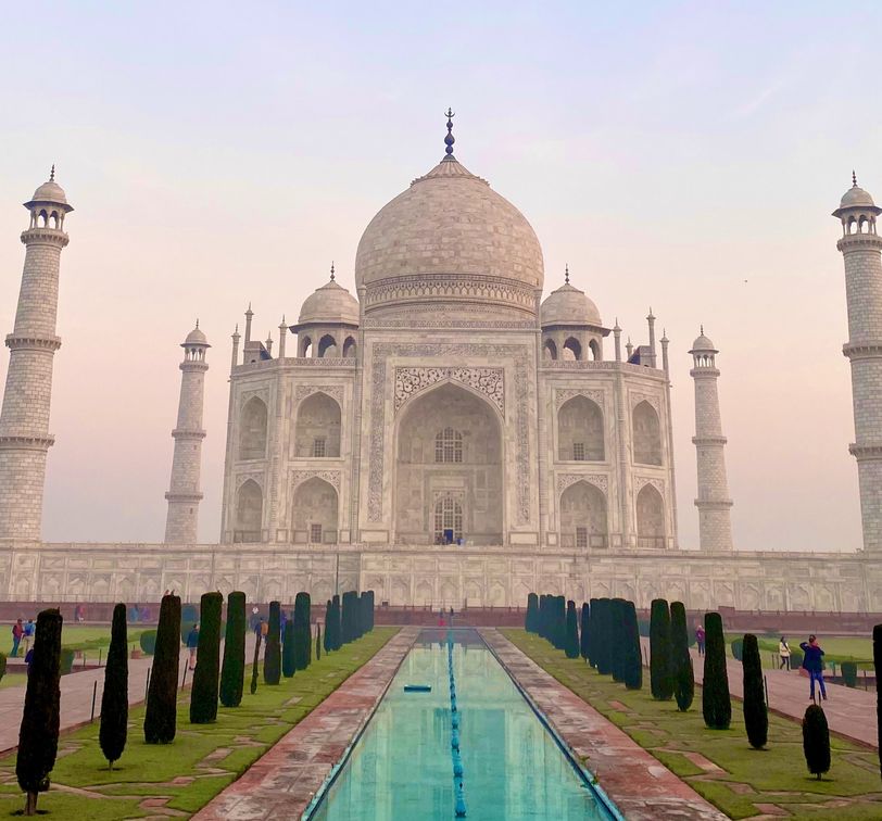 the taj mahal and the reflecting pool in front of it at sunset