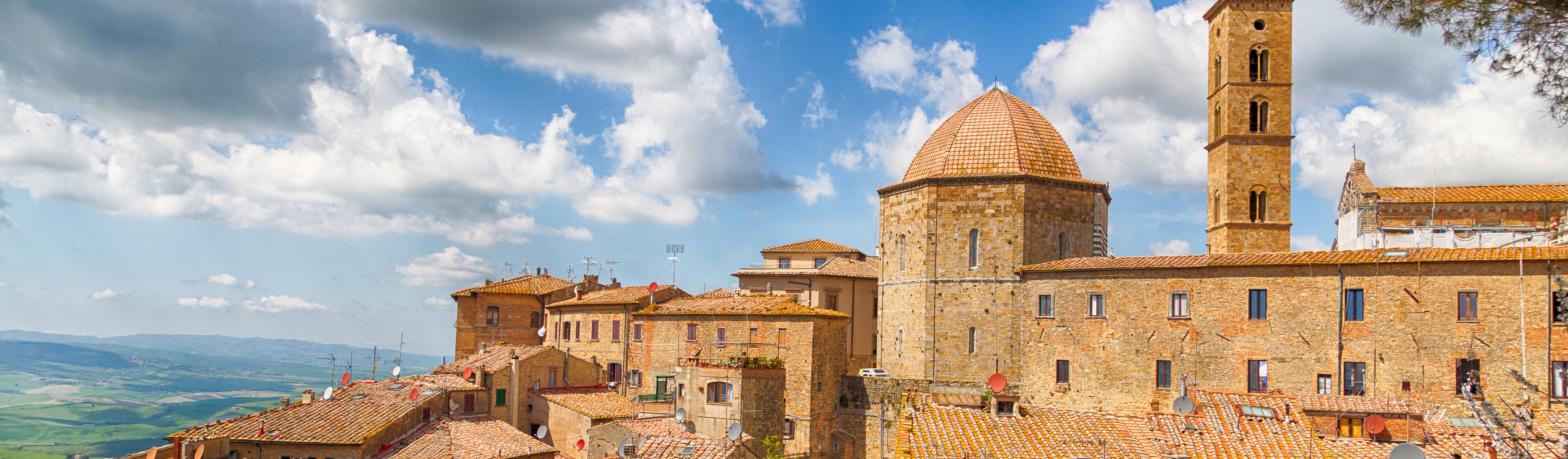 tan brick village of volterra in italy