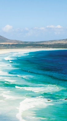 blue ocean waves crashing on the sand along the coast of south africa