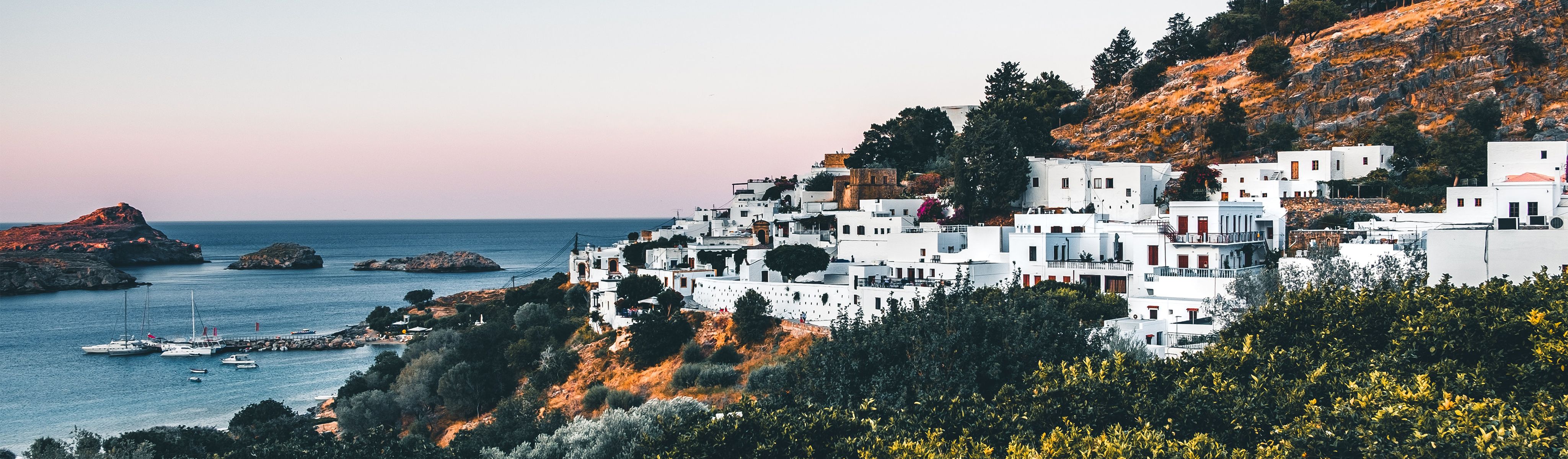 white buildings along the cliffs in rhodes greece