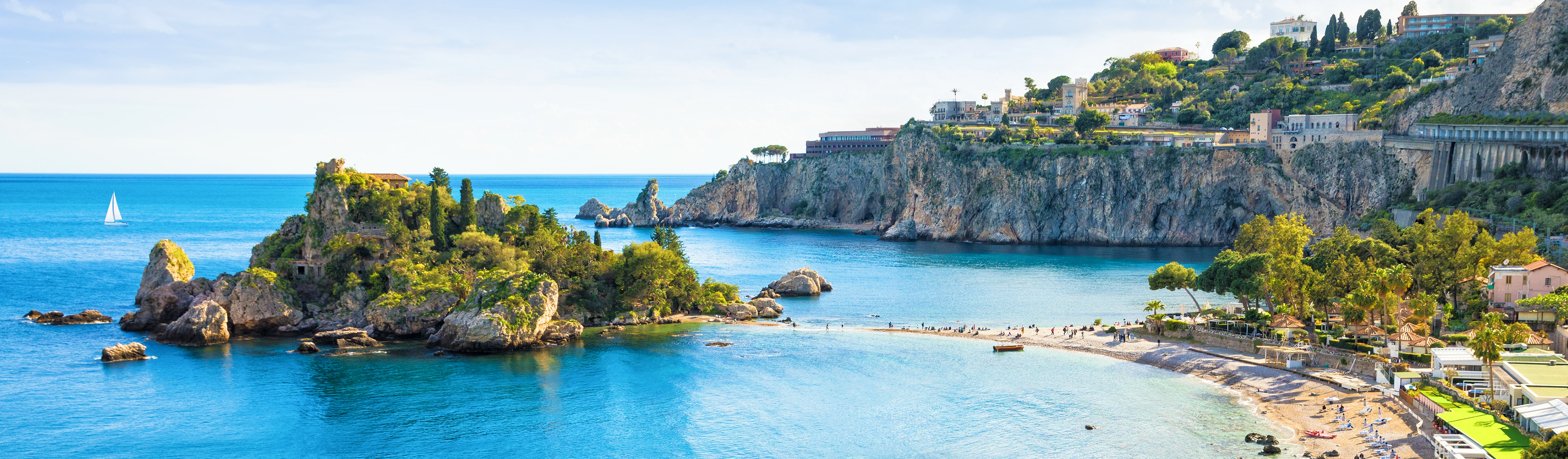 people walking along a bay in sicily italy