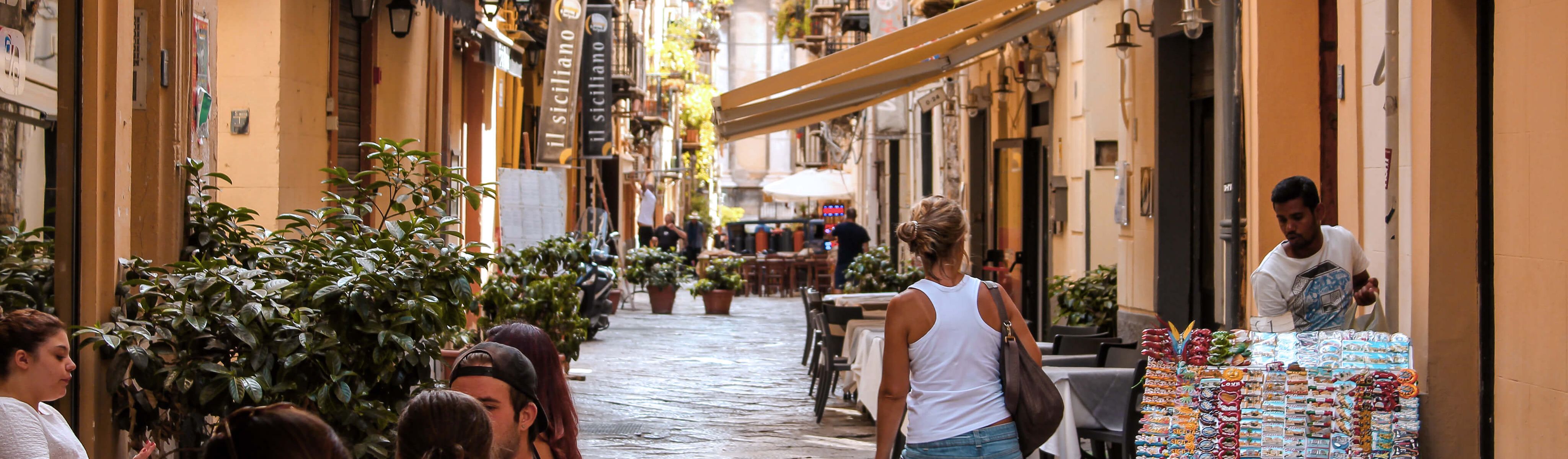 italian people walking down a street in italy