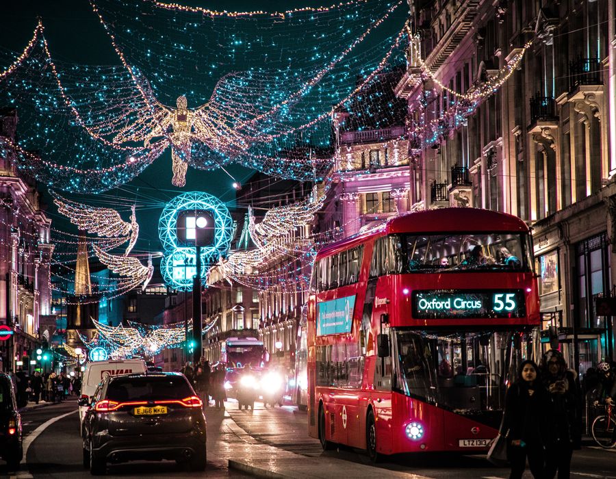 double decker bus riding through streets of london during christmas