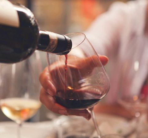 red wine being poured into a wine glass