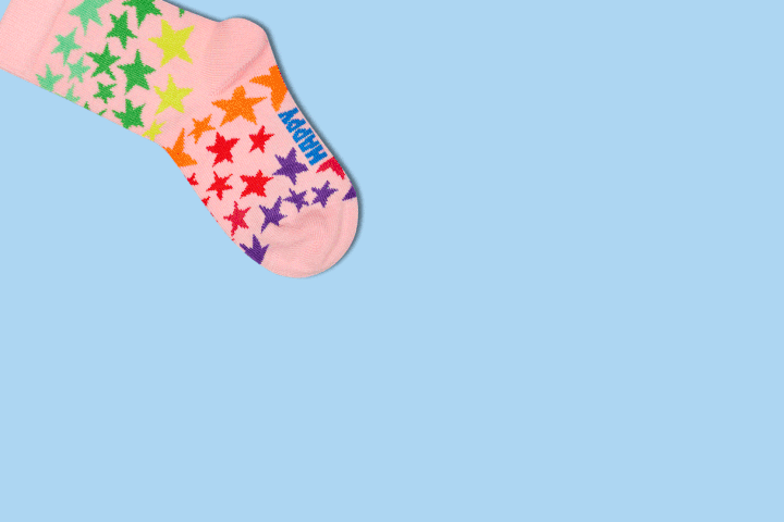 A pair of Cherry and Floral Kids Happy Socks on a blue background.