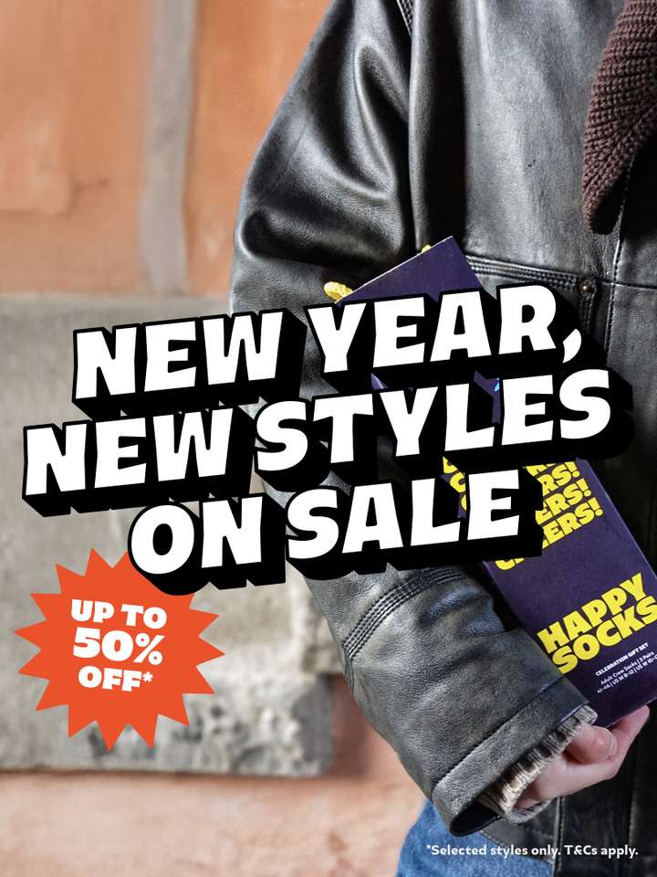 A person carrying a celebration Happy Socks gift set with text overlaid "New Year, New Styles On Sale. Up to 50% OFF"