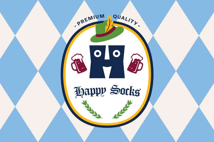 A Happy Socks gift set in the shape of a beer stein, and next to the stein are three Octoberfest-themed Happy Socks.