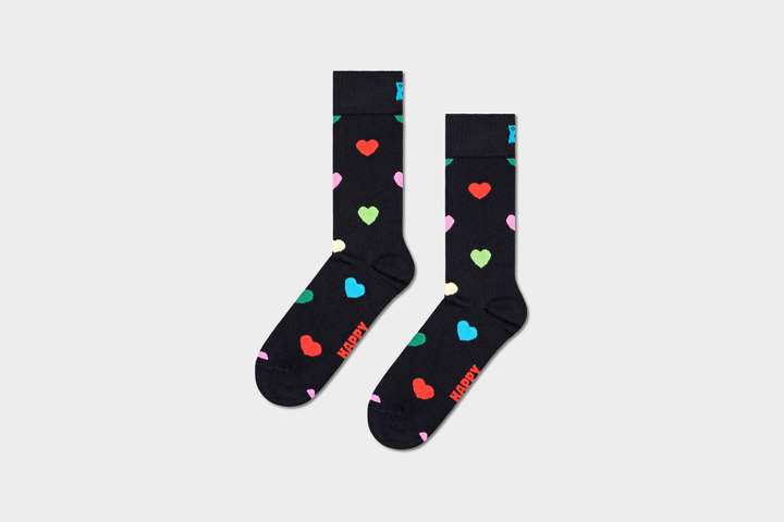 A pair of patterned black socks with colourful hearts.