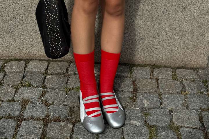 A pair of legs wearing Red Solid Happy Socks. 