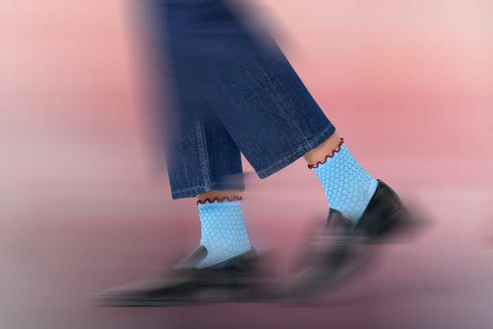 Legs wearing Happy Socks socks, blurred.