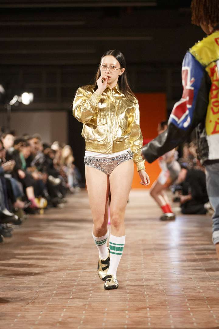 a women walking the runway wearing white and green happy socks