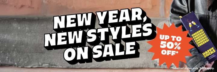 A person carrying a celebration Happy Socks gift set with text overlaid "New Year, New Styles On Sale. Up to 50% OFF"