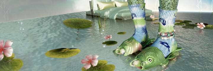 A pair of feet standing in a shallow pond full of lilypads. The feet are wearing a pair of sandals in the shape of fishes, as well as a pair of blue and green tie-dye Happy Socks featuring random symbols.