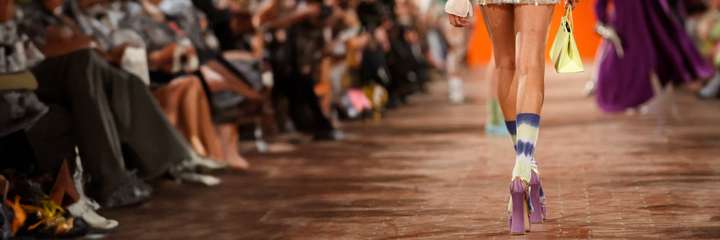 a person walking the runway wearing happy socks