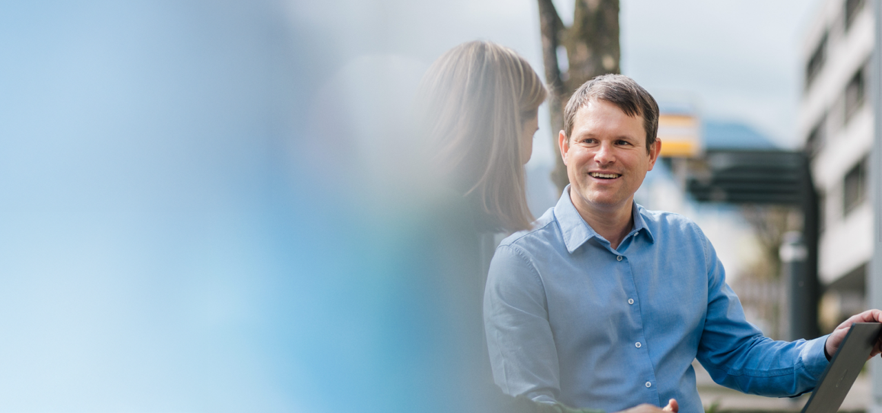 Octapharma employee talking with a colleague outside the headquarters in Lachen.