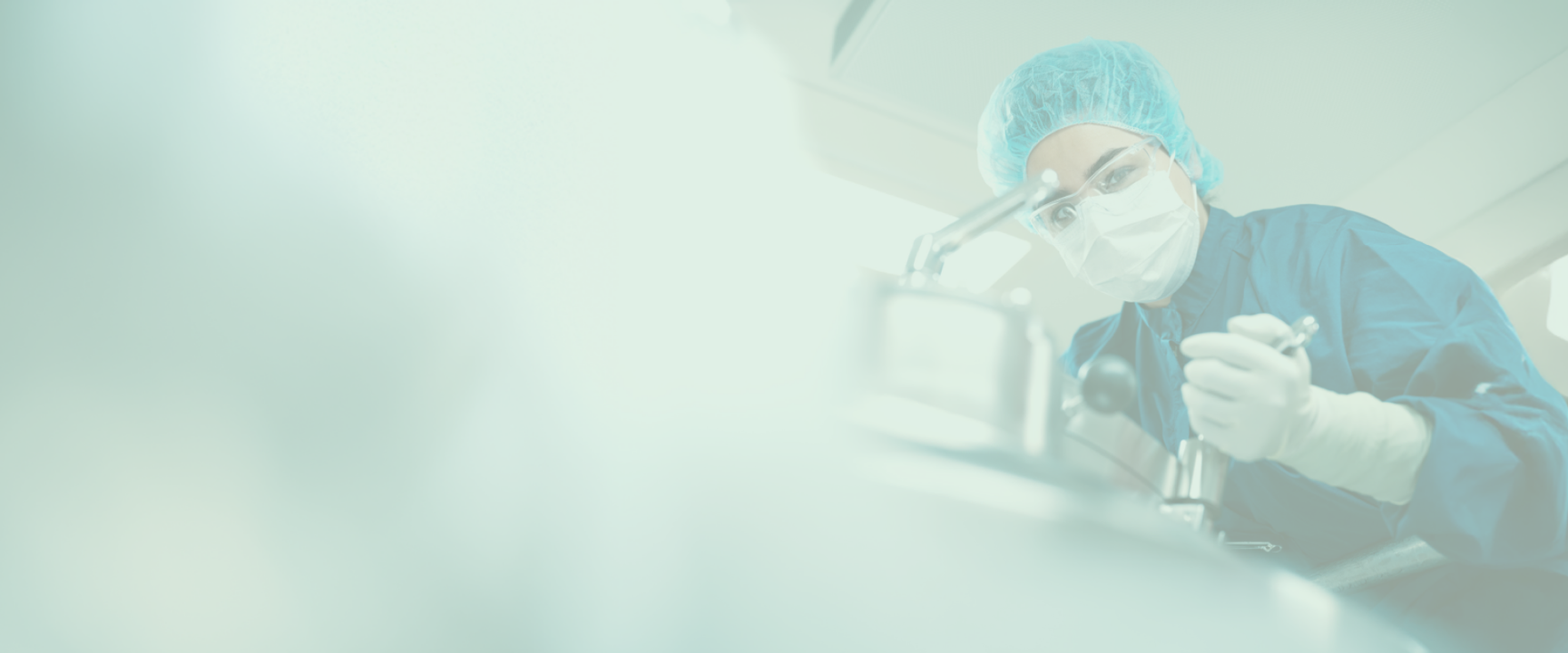 Octapharma employee in full protective gear operating production equipment in a sterile manufacturing environment.