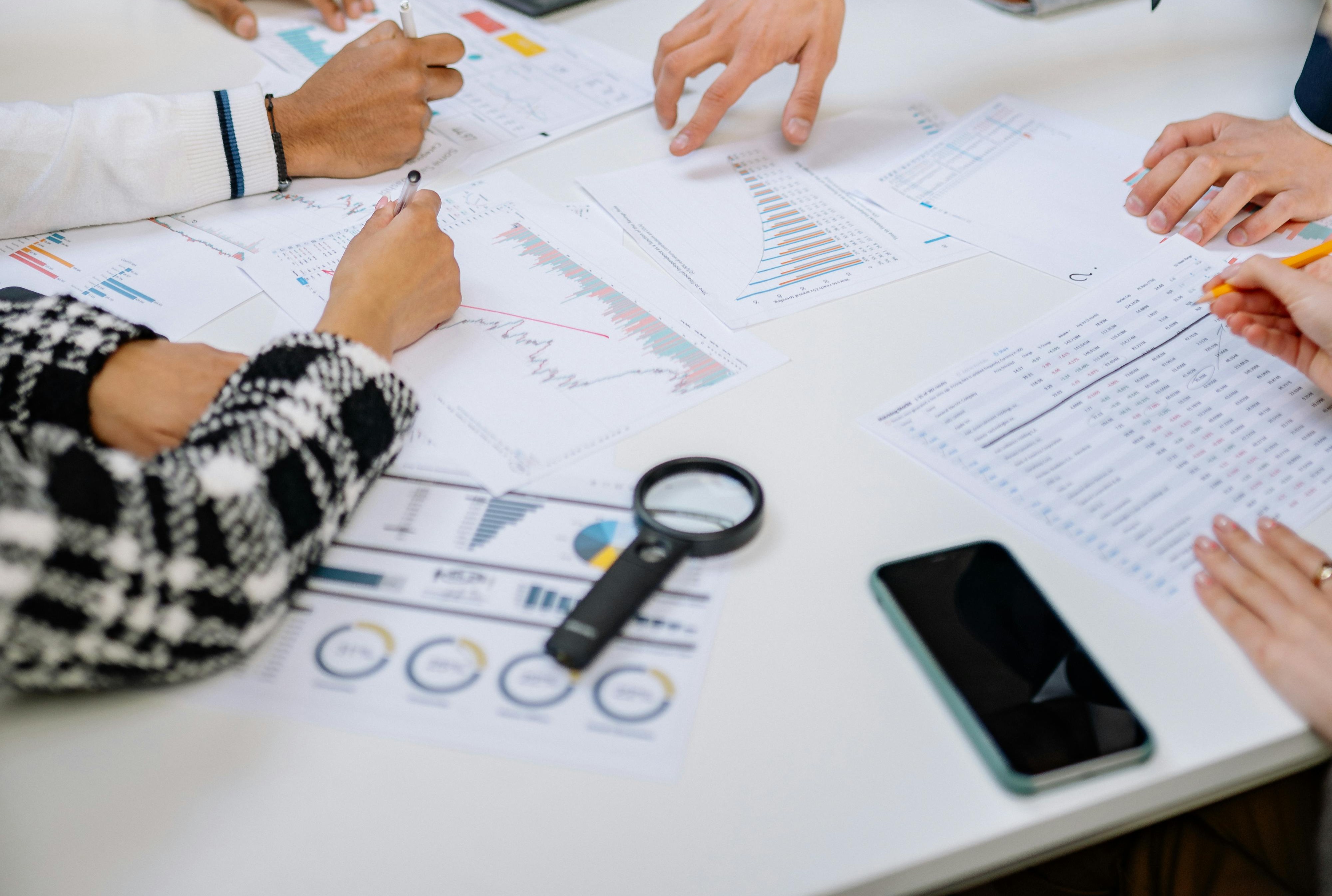 Team reviewing charts and regulatory documents at a desk, representing the detailed analysis and preparation required for biocidal product dossiers and compliance under BPR.