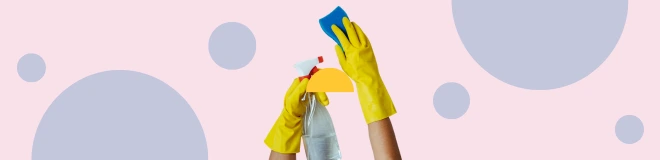 Hands wearing yellow rubber gloves holding a spray bottle and sponge against a pastel background, symbolising household surface cleaning and sanitation.