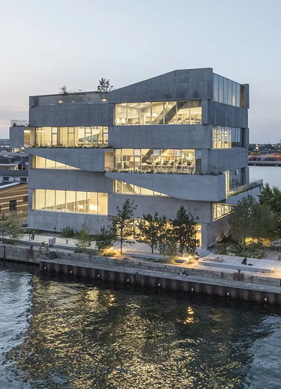 BIG's headquarters in Nordhavn seen from the harbour at dusk