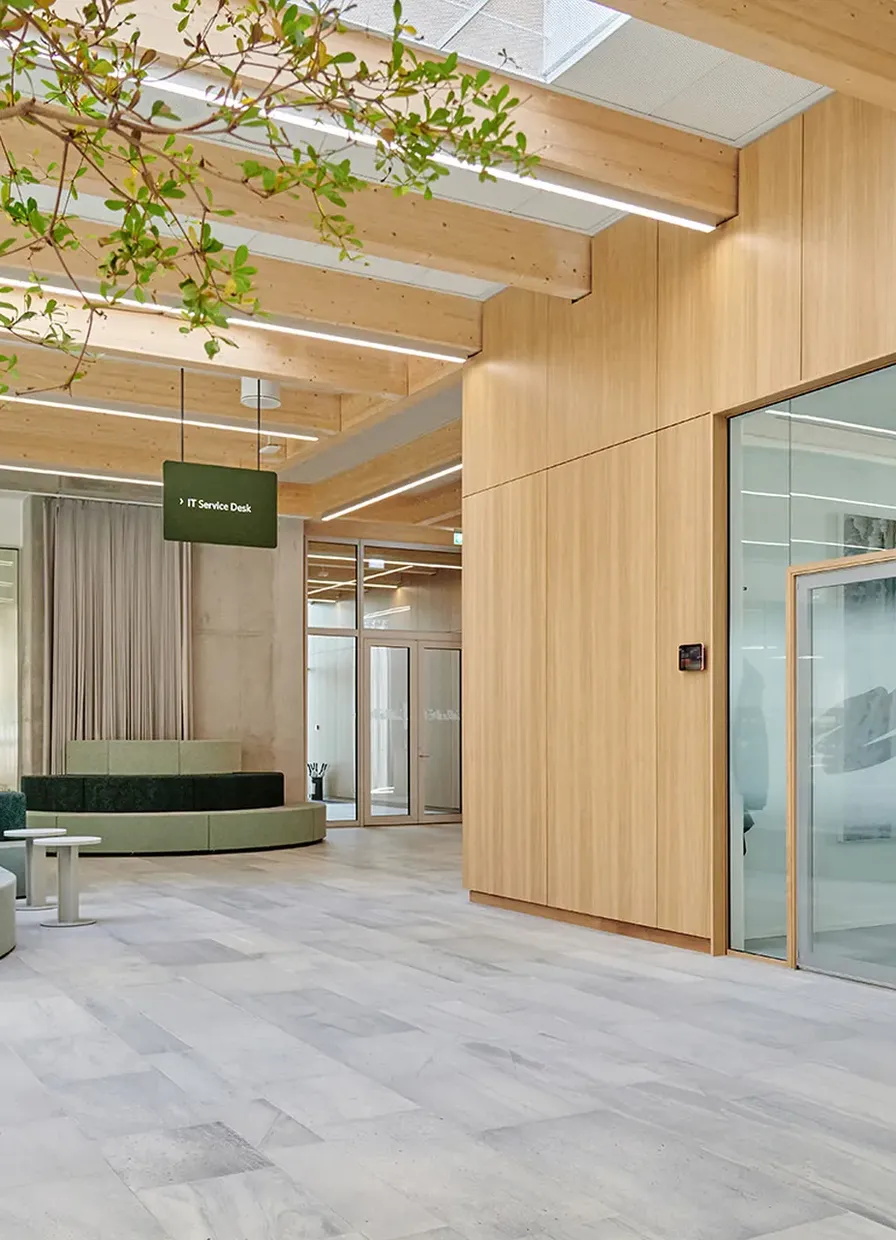 Timber-lined lobby at Novonesis Innovation Campus, with glazed partitions along the right
