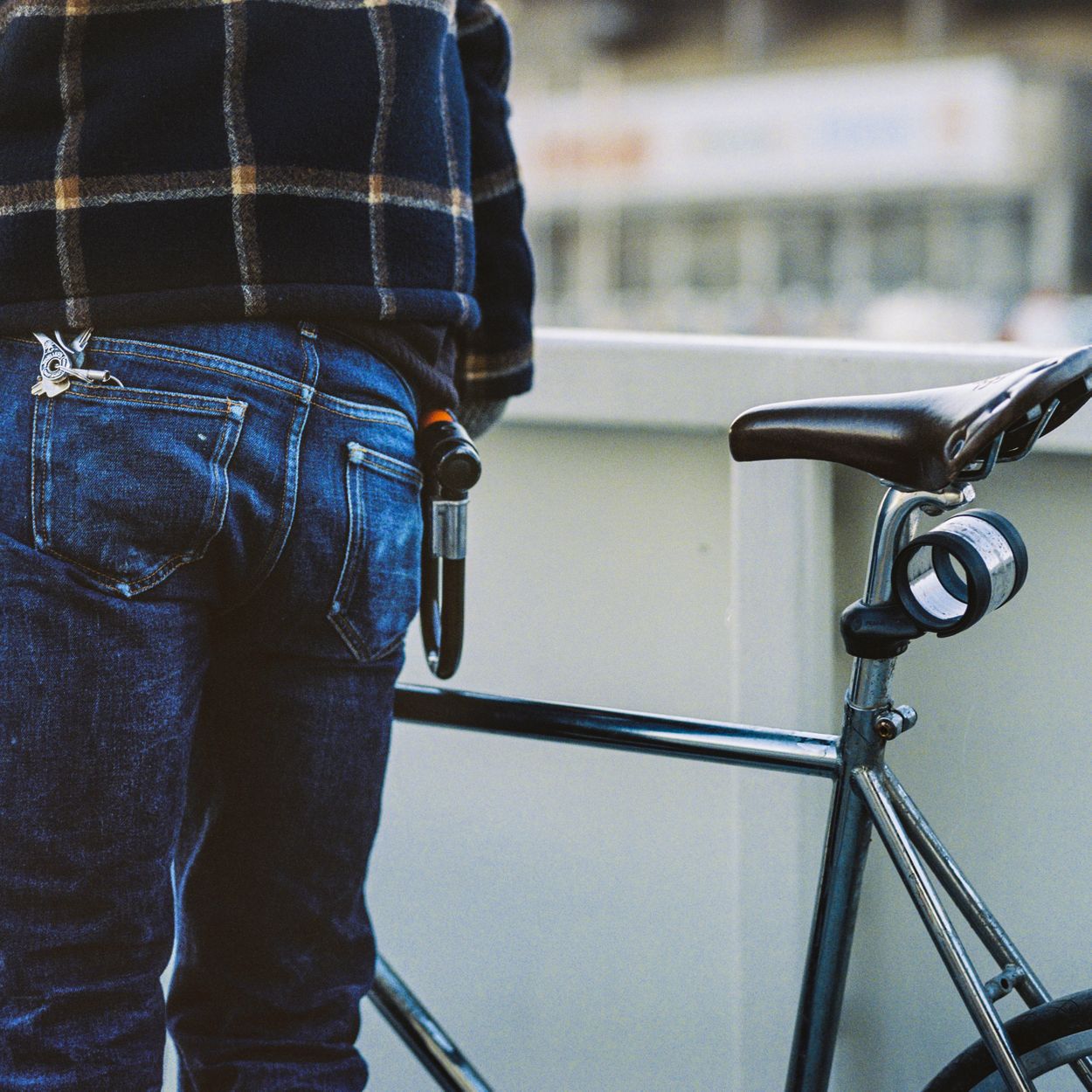 Man wearing Asket raw denim with his bike