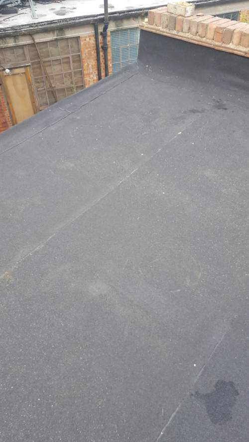 we took the flat roof membrane and chased it under the parapet walls were applicable