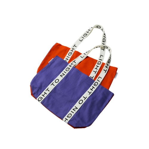 Orange and purple tote bag with white strap reading "LIGHT TO NIGHT"
