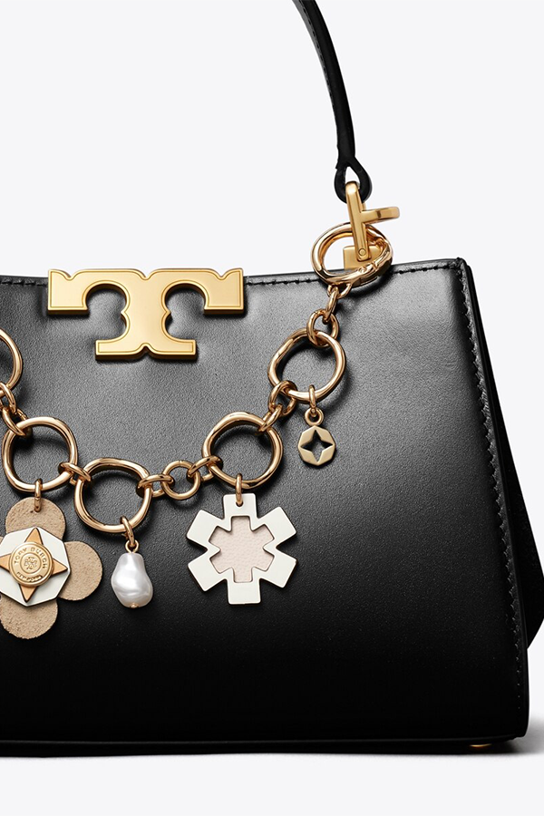 The charm bracelet, repurposed. Our bag chain features a mix of materials, textures and finishes — mother-of-pearl, leather and graphic metal cut-outs — on a gold chain. 