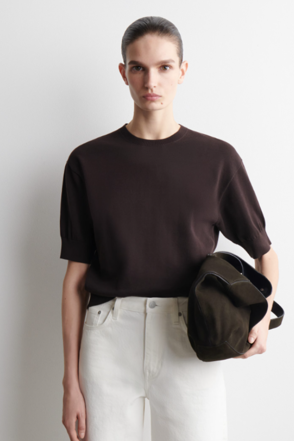 Refined essentials bring a fresh direction to the daily wardrobe. Offered in an earthy chocolate tone, this T-shirt is knitted from ultra-soft cotton and designed with a ribbed crew neck, short puffed sleeves and a ribbed hem. 