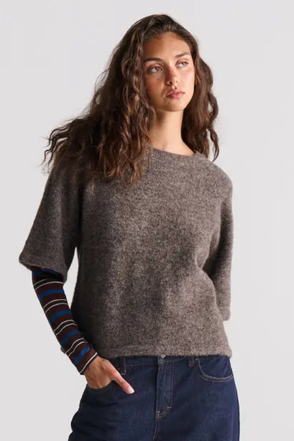The Tara Knit Top brings an effortless, laid-back energy to your knitwear collection. Crafted from a soft wool blend, this piece features a relaxed, boxy shape and an easy-going raglan design that hits with total comfort. The high crew neckline keeps things classic, while the elbow-length sleeves and chunky ribbed cuffs allow for seamless layering.