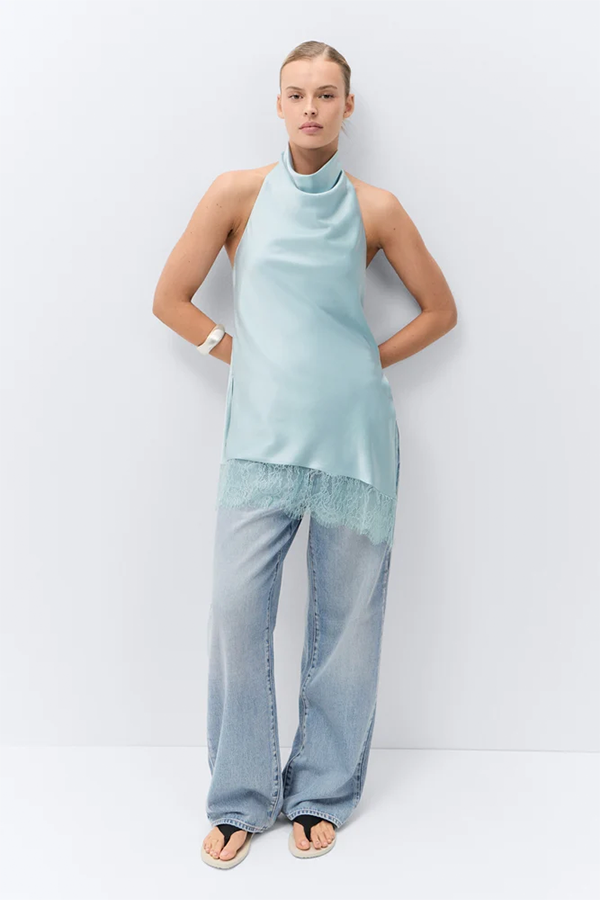 Lace meets liquid satin. This longline halter has a modern fluid drape, pairing a soft cowl neckline with a delicate lace trim hem. Pair it with our matching Satin Wide Leg Pant or vintage wash denim for a modern contrast.