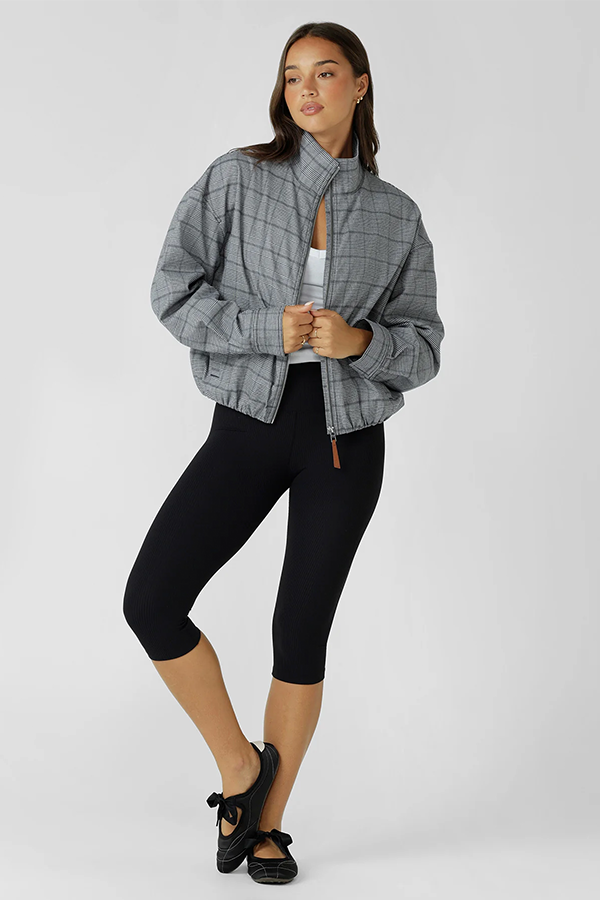 Soft touch comfort with a studio ready edge, the Studio Jacket is crafted from a cotton blend in a grey mini check with a neat bomber inspired silhouette, high athletic neckline and adjustable cuffs that help trap in warmth. 