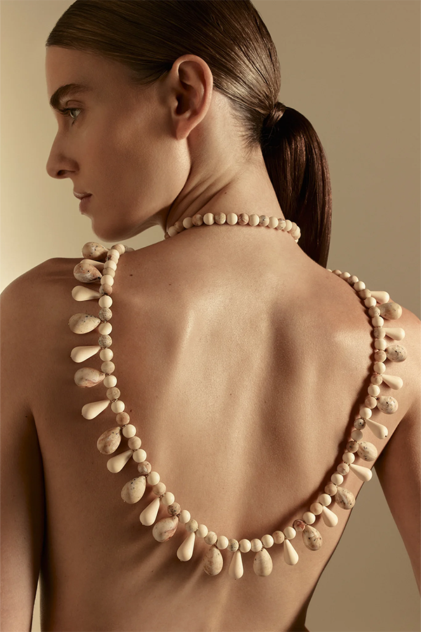 Tactile and elegantly long, the Italian Resin Drop Necklace falls in a fluid 124cm line. Made in Italy with resin beads and brass trim with 14k light gold plating, it fastens with a secure clasp closure. 